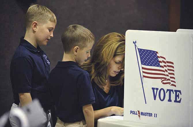 Dawson, 7, and Christopher Earney, 10, get a firsthand view of the ballot and the voting process as they visited CC General Precinct at Southridge Baptist Church with their mother, Jodie Earney. After voting, the boys were dropped off at St. Peter School for the day.