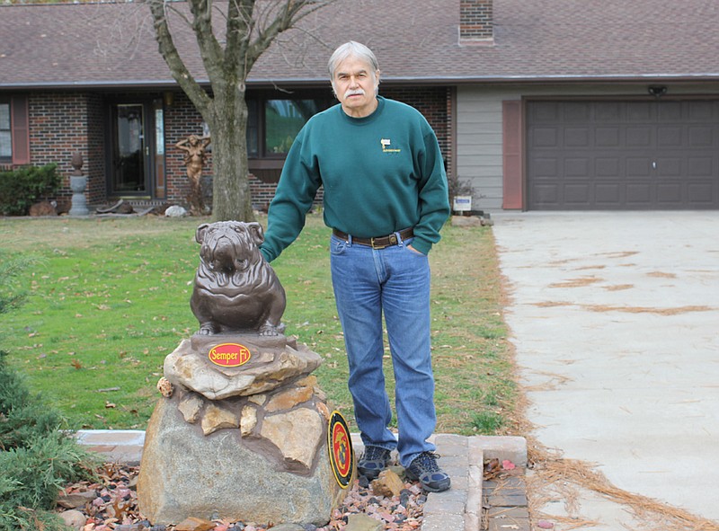 Dennis Byler stands by the Marine Bulldog that guards his driveway off Lake View Drive. The Marine veteran will receive two Purple Hearts he earned was never given during his tour in Vietnam 44 years ago. 