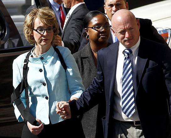 Former Democratic Rep. Gabrielle Giffords, left, and her husband, Mark Kelly, leave Thursday after the sentencing of Jared Loughner, in Tucson, Ariz. U.S. District Judge Larry Burns sentenced Jared Lee Loughner, 24, to life in prison, for the January 2011 attack that left six people dead and Giffords and others wounded. 