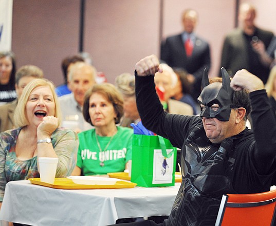
Batman, also known as John Kehoe, flexes his muscles, evoking laughter from last year's co-chair, Ann Littlefield, left. The United Way of Central Missouri hosted its 2012 Victory Celebration at the Missouri Farm Bureau Thursday morning.