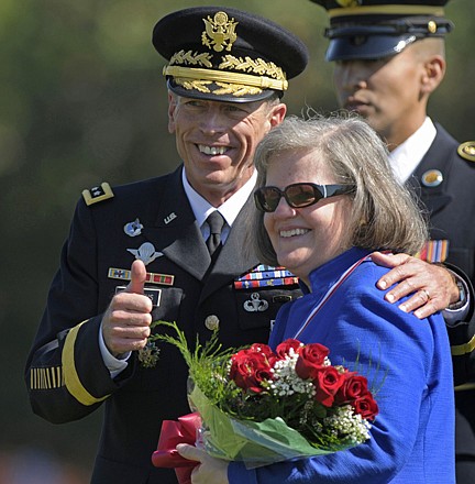 Gen. Davis Petraeus, standing with his wife Holly, participates in an armed forces farewell tribute and retirement ceremony at Joint Base Myer-Henderson Hall in Arlington, Va., with his wife, Holly, on Aug. 31, 2011. Gen. Petraeus, the retired four-star general who led the U.S. military campaigns in Iraq and Afghanistan, resigned Friday as director of the CIA after admitting he had an extramarital affair.