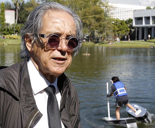 Architecture Professor Jaime Canaves talks to a reporter Thursday during a "Walk on Water" event  at Florida International University in Miami. Canaves' Materials and Methods Construction Class is assigned to build aquatic shoes that will allow the students to race across a campus lake by literally walking on water. 