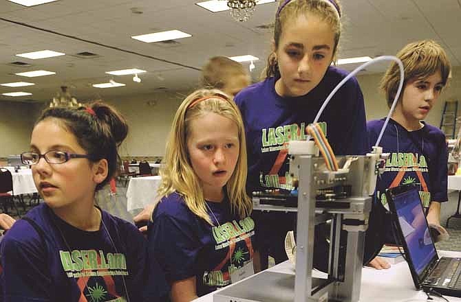 Members of the Camdenton 4-H Laser Team watch Saturday as a 3D printer creates a heart during the Missouri Educational Robotics Conference at Truman Hotel in Jefferson City.
