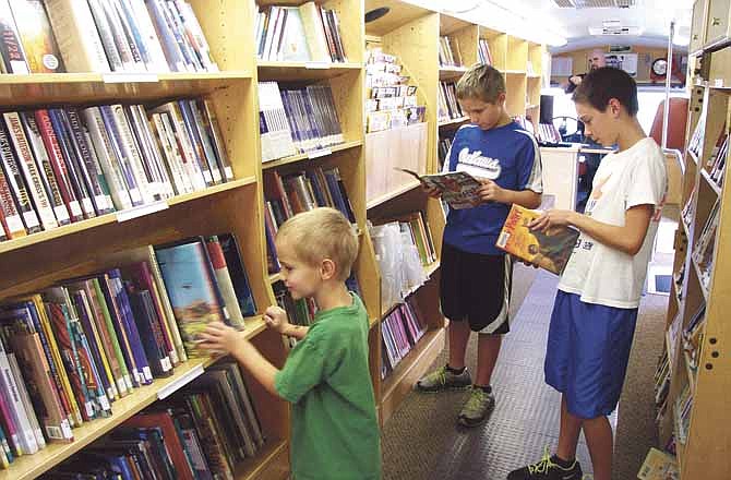 Damian Miller, 14, brought his brothers Chandler, 11, and Reese, 6, to the Missouri River Regional Library's bookmobile Saturday while it was stopped in Russellville.