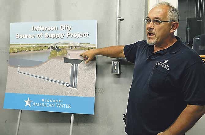 In this July 2012 file photo, Missouri American Water Company employee Steve Ridenhour explains operations to a group of Lincoln University students.