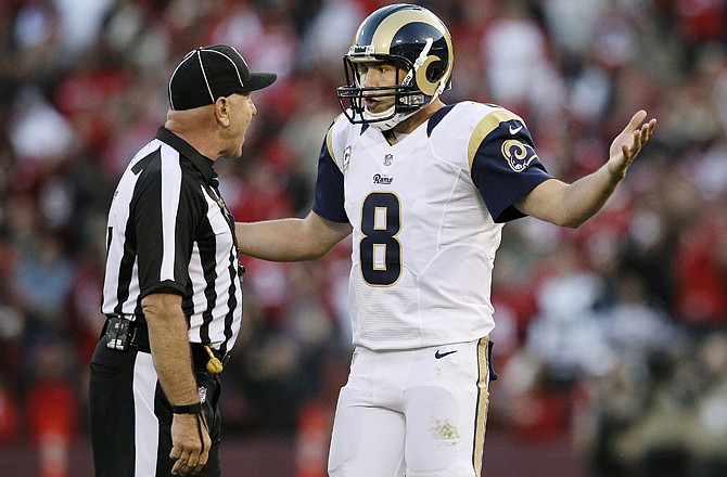 Rams quarterback Sam Bradford (8) argues with umpire Garth DeFelice after a pass to wide receiver Danny Amendola was called back by a penalty during overtime against the 49ers on Sunday in San Francisco.