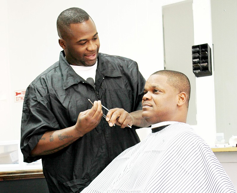 James Pittman of Fulton gives a haircut and a shave to his first customer, Stacy Chiles of Fulton, at Pittman's new business, JP's Barber Shop, at 612 Court St. in downtown Fulton.
