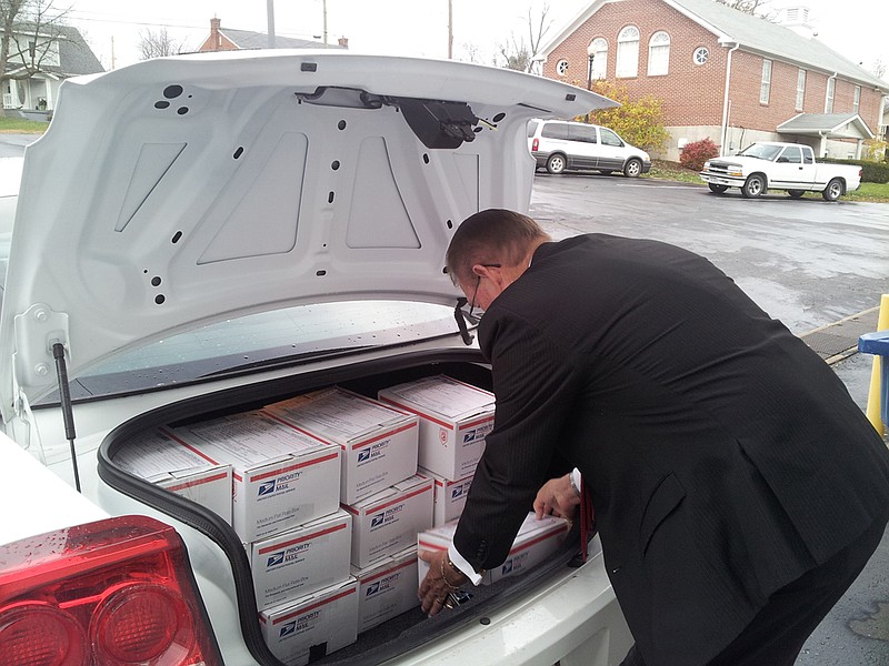 Debo Funeral Home employee Spencer Palmer loads Lori Dillon's car with care packages to send to troops overseas during the funeral home's drive last year. This year, the Callaway County EOC is asking the county to send care packages including toiletries, snacks and letters for the drive.