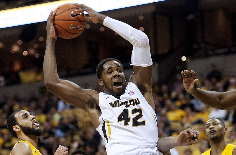 Missouri's Alex Oriakhi (42) falls to the court after grabbing a rebound in the midst of several Alcorn State players during the first half of Tuesday's game in Columbia.