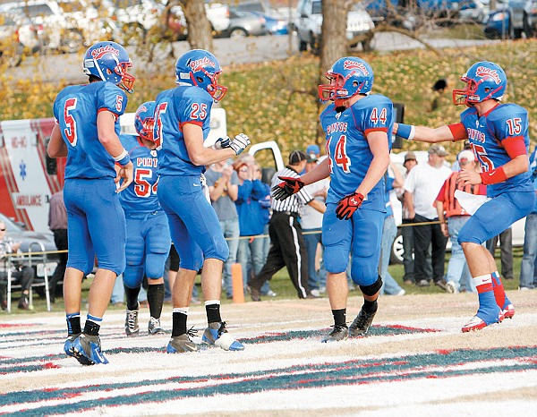 California's Jason Wolverton (44) extends a hand to congratulate teammate Logan Rowles (25) on his touchdown with 10:49 remaining in the Class 3 Quarterfinal game against Duchesne Saturday at Riley Field. Rowles' TD gave the Pintos their first lead of the game. Rushing in to give Rowles an "attaboy" are Dylan Albertson (5), Jaden Barr (15), and Curtis Fulks (54). California went on to defeat the Pioneers 21-12 to advance to Class 3 Semifinals at 1:30 p.m. Saturday at Maryville. 
