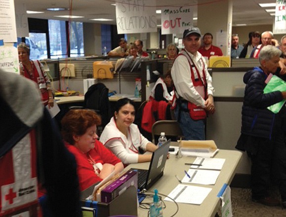 Red Cross volunteers man a registration desk at a help center in New York.