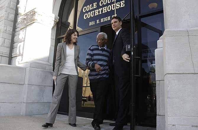 Flanked by attorneys Olga Akselrod, left, and Ameer Gado, right, George Allen Jr. walks out of the Cole County Courthouse after being released from custody Wednesday, Nov. 14, 2012, in Jefferson City, Mo. A Cole County judge overturned a 95-year prison sentence Nov. 2 and ordered Allen's release after spending nearly three decades in prison on rape and murder convictions, ruling police had withheld evidence that raised questions about Allen's guilt. 