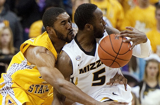 Keion Bell of Missouri spins away from Alcorn State's Jamaal Hester as he heads toward the basket during the second half of Tuesday night's game at Mizzou Arena.