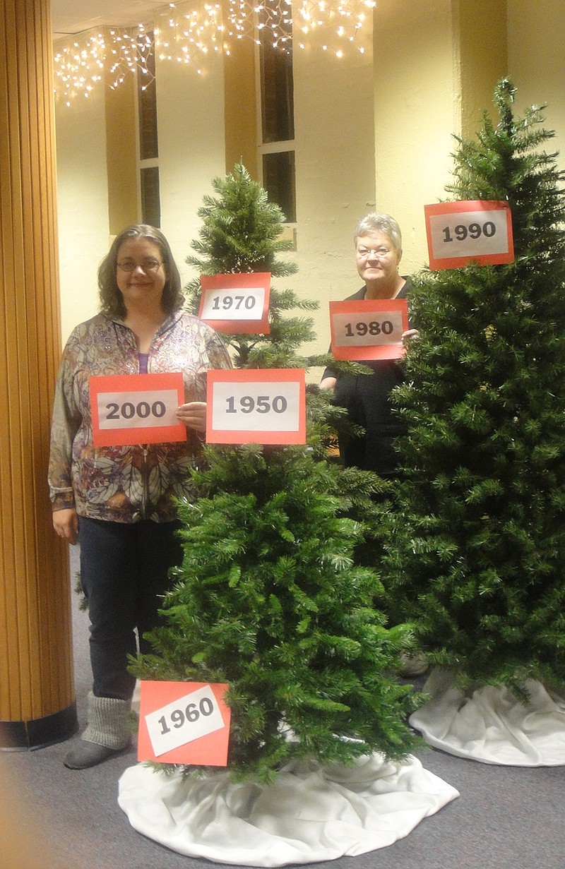 Mallory Rueter, left, and Linda Mealy of Court Street United Methodist Church begin preparing six trees to represent the six decades of the church's annual Christmas Bazaar. The 60th event will feature time honored staples of the bazaar, such as homemade pies and crafts, and will also feature new attractions like the trees.