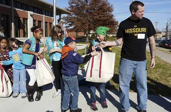 More than 300 library patrons came out Saturday to help celebrate the construction of a new library building in Ashland, Mo. The morning event featured a jazz band, snacks, a ribbon cutting and a "book brigade" of community helpers who delivered materials from the old building to the new one.