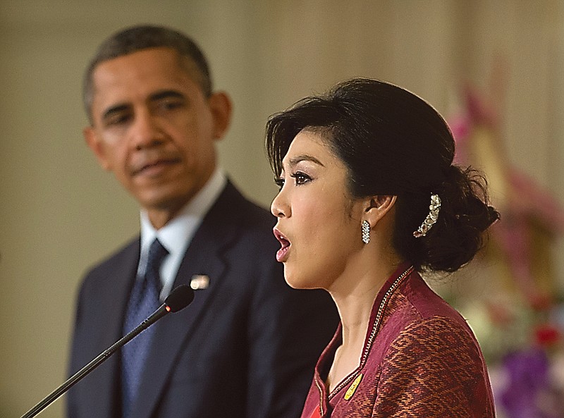 President Barack Obama listens as Thai Prime Minister Yingluck Shinawatra speaks during a joint news conference in Bangkok, Thailand.