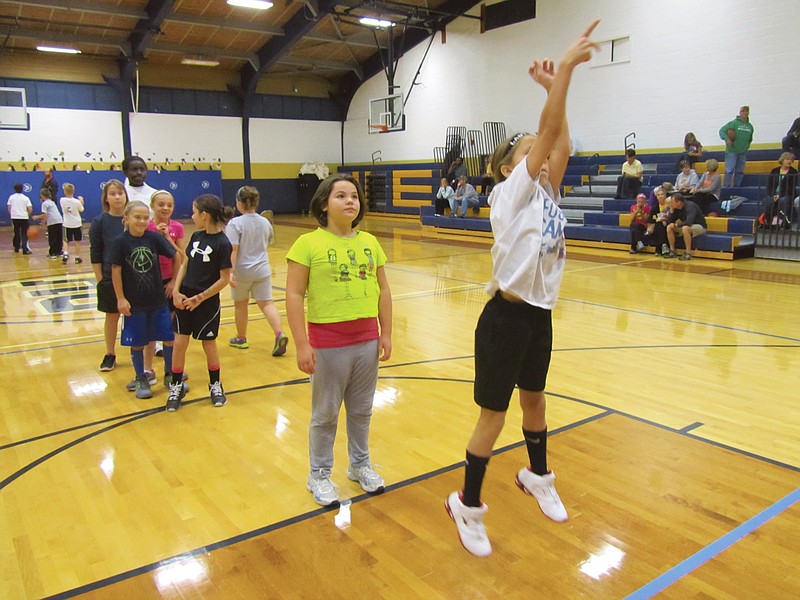 Maura Pardoe, 9, California, takes a practice shot before Sunday's Elks 513 Hoop Shoot Free Throw Contest at the Helias Catholic High School Fieldhouse on Sunday. Pardoe finished second in her age group as about a dozen kids competed for a chance to compete at the district level.         