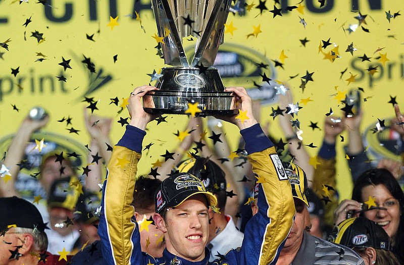 Brad Keselowski holds the trophy after winning the Sprint Cup Series championship following Sunday's race at Homestead-Miami Speedway in Homestead, Fla.