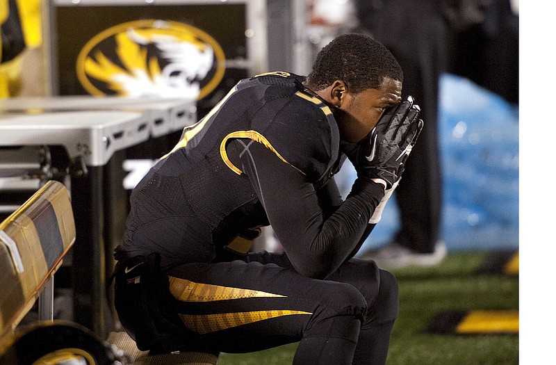 E.J. Gaines of Missouri sits on the bench as he watches Syracuse celebrate after its 31-27 victory Saturday night at Faurot Field.