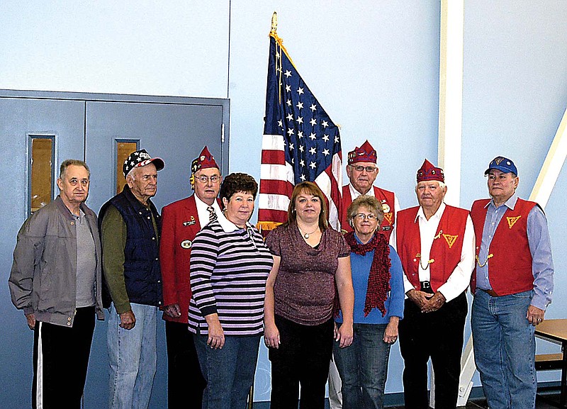 A new fringed American flag on a telescoping pole has been presented to the Latham School by the Class of 1961. Special guests present for the presentation are, front row from left, Wanda (Dowell) Wilde, Tanya Brown, Earlene (Pardoe) Heck; back row, veterans Bob Schreck, Dean Irey, Tony Gallagher, Don Barbour, Robert Fulton and Jodie Heck.   

