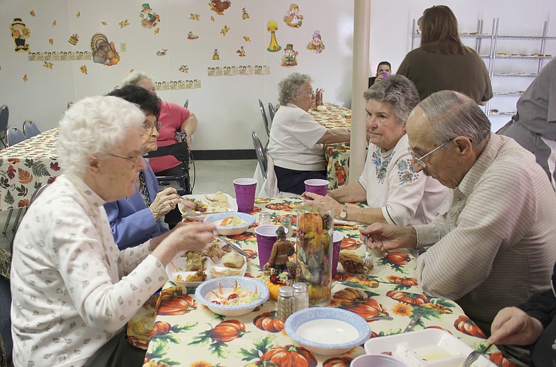 (Clockwise, from front, left) Margaret Clardy, Helen Nichols, Betty Crawford and Matt Kowalewski enjoy their meal of turkey, ham and all the trimmings at the Community Thanksgiving Dinner at New Bloomfield United Methodist Church Thursday. The group was one of many that came out to enjoy the holiday together.