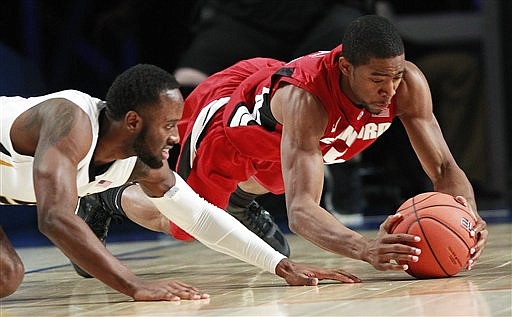 Stanford guard Chasson Randle, right, and Missouri guard Keion Bell dive for a loose ball during the first half of an NCAA college basketball game at the Battle 4 Atlantis tournament, Thursday, Nov. 22, 2012 in Paradise Island, Bahamas.