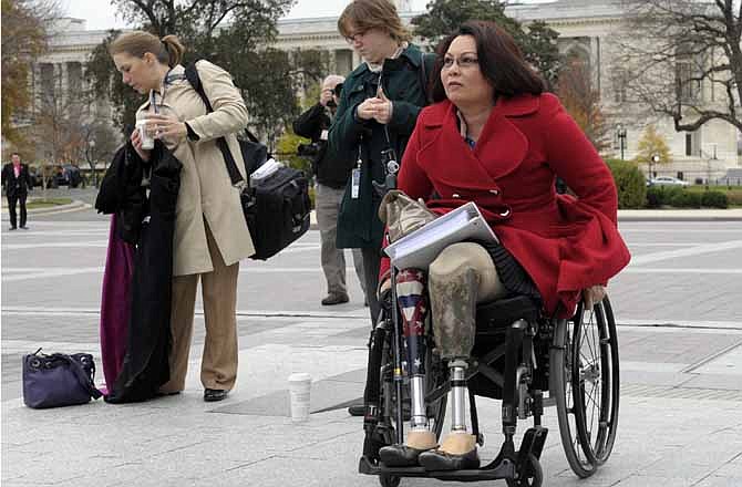 This Nov. 15, 2012 file photo shows Iraq war veteran, Rep.-elect Tammy Duckworth, D-Ill., who lost both legs in combat before turning to politics, arriving for a group photo on the East steps of the Capitol in Washington. Veterans groups say the influx of Iraq and Afghanistan veterans in Congress is welcome because it comes at a time when the overall number of veterans in Congress is on a steep and steady decline. In the mid-1970s, the vast majority of lawmakers tended to be veterans. 