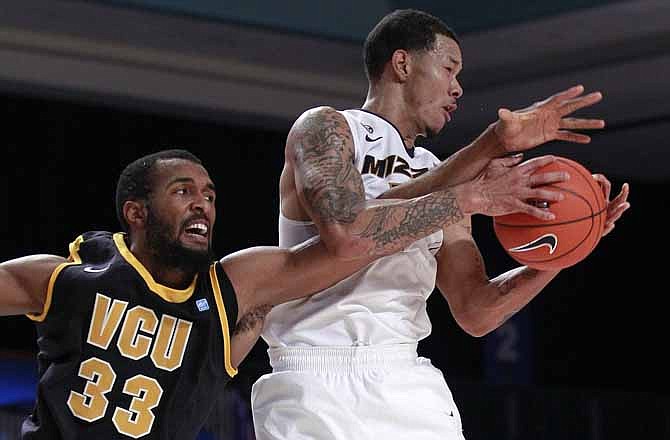 Missouri guard Negus Webster-Chan (14) grabs a rebound against Virginia Commonwealth center D.J. Haley (33) during the first half of an NCAA college basketball game at the Battle 4 Atlantis tournament, Saturday, Nov. 24, 2012 in Paradise Island, Bahamas.