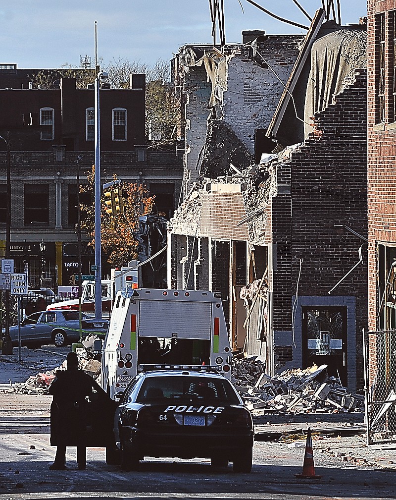 Police keep a perimeter around the area where a gas explosion leveled a strip club in Springfield, Mass., on Friday evening. Investigators were trying to figure out what caused the blast where the multistory brick building housing Scores Gentleman's Club once stood.