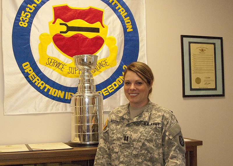 Capt. Kati Mudd of Jefferson City stands next to the trophy she was recently awarded by 70th Troop Command for her exceptional administrative support to the 835th Combat Sustainment Support Battalion. 