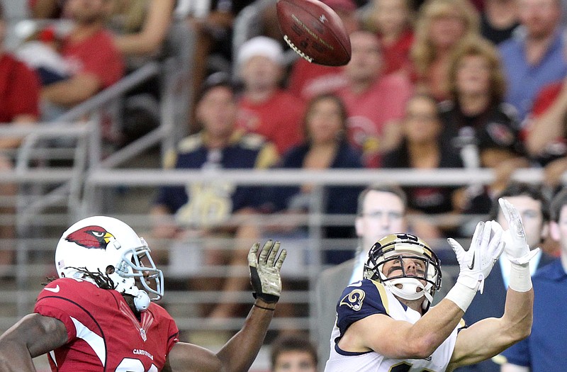 Rams wide receiver Danny Amendola pulls in a pass as Cardinals cornerback Jamell Fleming tries to defend during Sunday's game in Glendale, Ariz.