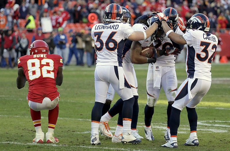 Broncos teammates celebrate around free safety David Bruton after he intercepted a pass intended for Chiefs wide receiver Dwayne Bowe late in Sunday afternoon's game at Arrowhead Stadium.