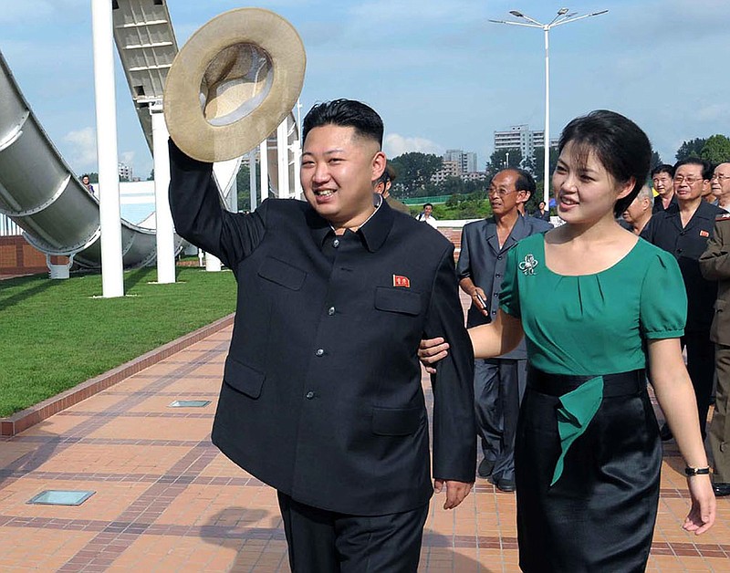 North Korean leader Kim Jong Un, accompanied by his wife Ri Sol Ju, waves to the crowd as they inspect the Rungna People's Pleasure Ground in Pyongyang, North Korea. The online version of China's Communist Party newspaper has hailed a report by The Onion naming Kim as the "Sexiest Man Alive" - not realizing it is satire.