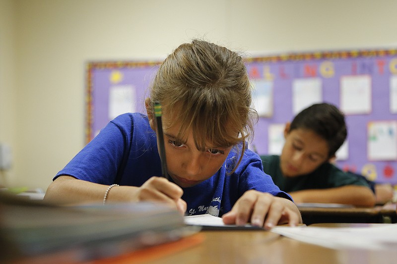 Alexia Herrera practices writing in cursive at St. Mark's Lutheran School in Hacienda Heights, Calif. Bucking a growing trend of eliminating cursive from elementary school curriculums or making it optional, California is among the states keeping longhand as a third-grade staple.