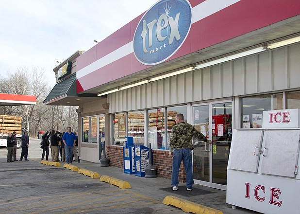 A customer enters Trex Mart as members of the news media gather Thursday in Dearborn, Mo. Trex Mart sold one of Wednesday night's winning Powerball tickets, and the winner will be revealed this morning.