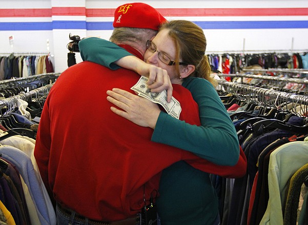Janice Kennedy hugs Secret Santa after getting four $100 dollar bills Thursday from the wealthy anonymous philanthropist from Kansas City while she was looking for clothes at the Salvation Army store in the borough of Staten Island, N.Y. Secret Santa distributed $100 dollar bills to needy people at several locations in Elizabeth, N.J., and Staten Island.