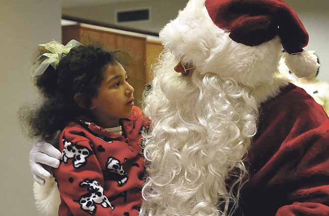 In this News Tribune file photo, Dmiya Grover talks to Santa during the 2011 Living Windows event in downtown Jefferson City.