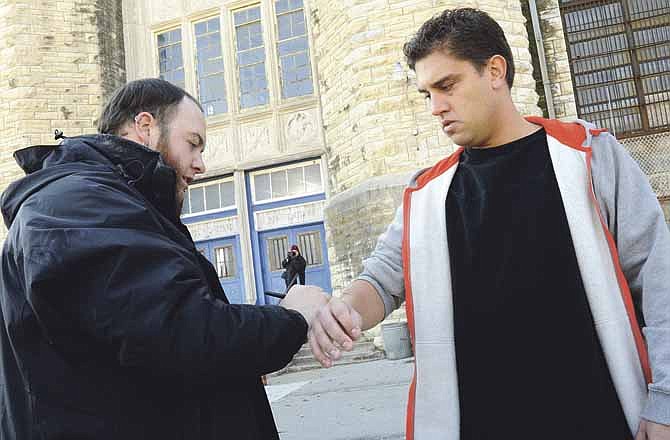 Special makeup effects artist Nick Reisinger, left, perfects a deep scratch on the arm of local actor Jay Shipman, who plays Intern I. Cast and crew have been busy filming scenes at the old Missouri State Penitentiary in Jefferson City for an independent movie, "Apparitional," expected to be released early next year.