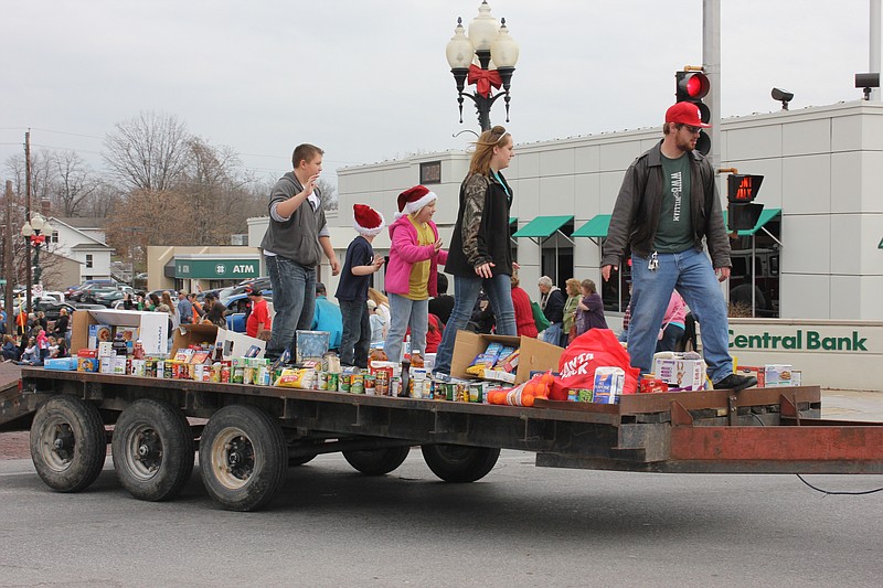 The final float in the Fulton Jaycees Christmas Parade Saturday afternoon was a trailer piled with food donated by all of the parade participants. In addition to the 9,546 pounds of canned and dry goods brought to the parade, enough money was donated to purchase an additional 5,364 pounds, bringing the total amount donated to SERVE to 14,910 pounds of food. The Callaway Bass Anglers brought in the largest donation giving the equivalent of 1,200 pounds of food.