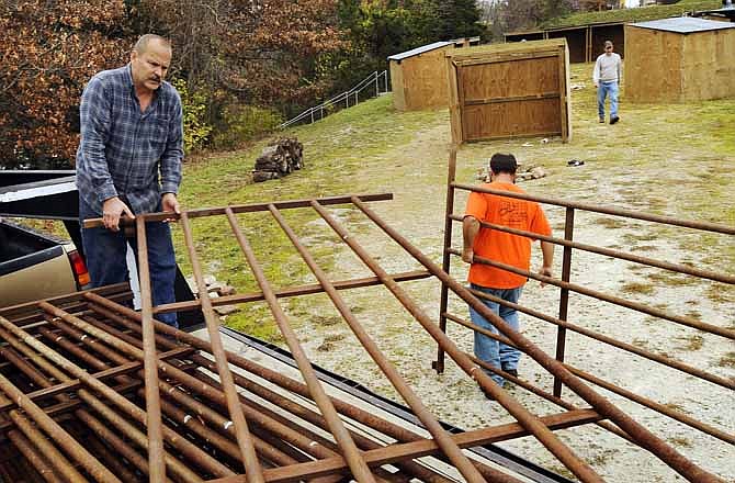 Mike Wankum, left, and Matt Kremer unload fence panels as they and others help set up the town of Bethlehem on Saturday morning during preparations for Capital City Christian Church's upcoming 20th annual "Journey to Bethlehem" Christmas program.