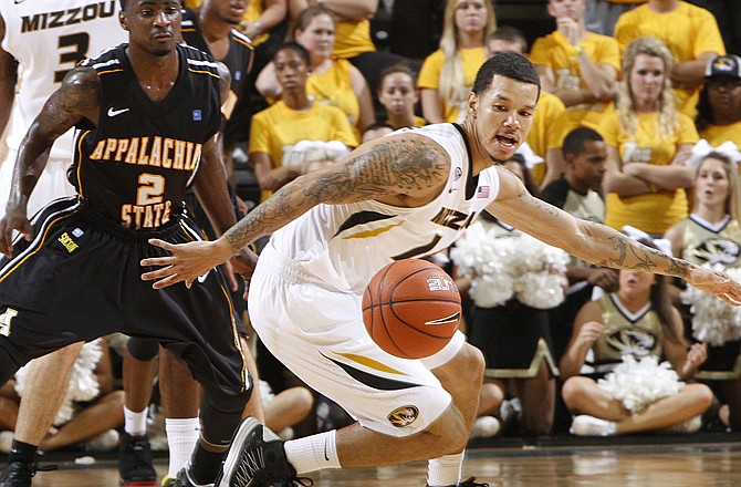 Missouri guard Negus Webster-Chan (right) turns to recover the ball while dribbling against Appalachian State guard Tab Hamilton during the second half Saturday in Columbia. Missouri won 72-56.