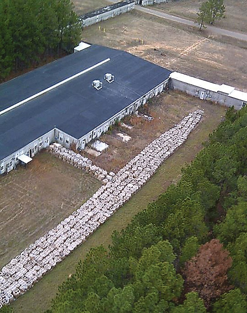 This aerial photo provided by the Louisiana State Police shows part of the smokeless explosive powder improperly stored outside Explo Systems Inc., a munitions dismantling facility at Camp Minden at Doyline, La.