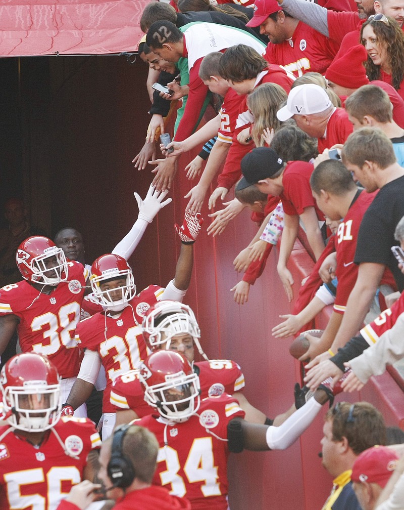 Chiefs players greet fans as they exit the tunnel before their game against the Carolina Panthers on Sunday at Arrowhead Stadium in Kansas City.