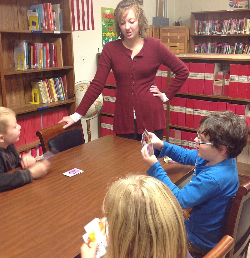 First-grade teacher Amy Schroer supervised a game of Go Fish! among after-school activities for students.