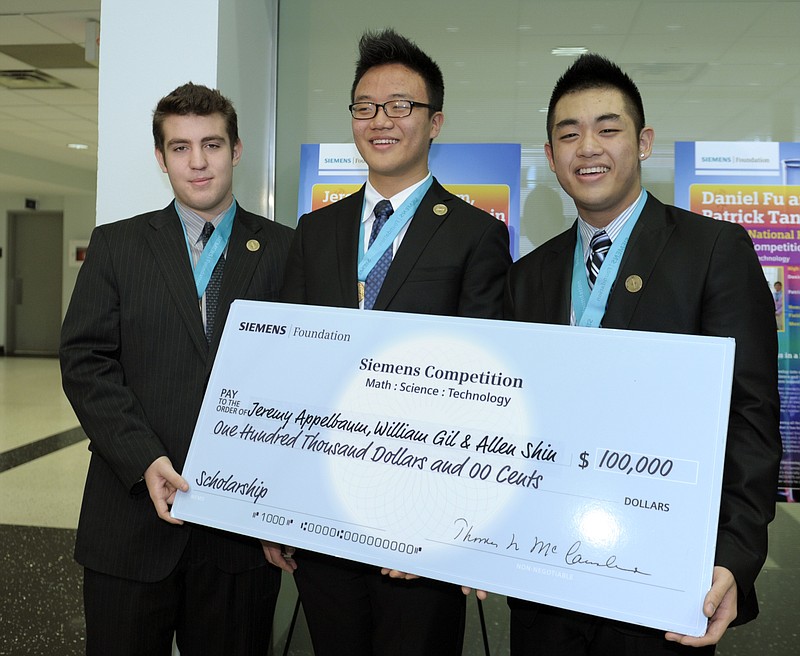 George W. Hewlett High School in Hewlett, N.Y. students, from left, Jeremy Appelbaum, William Gil and Allen Shin pose with their scholarship check Tuesday at George Washington University in Washington after being named the top winners of the Siemens Competition in Math, Science & Technology National Finals.