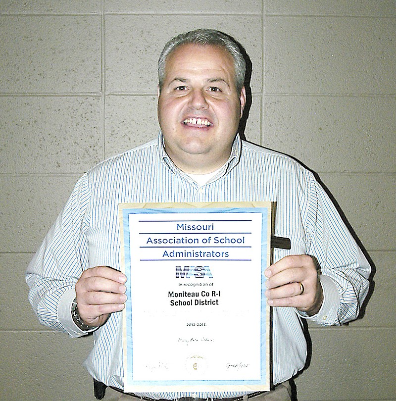 Dwight Sanders with the certificate of recognition presented by the Missouri Association of School Administrators. This certificate is based on the same criteria as the Distinction of Performance award which is no longer being given by the Missouri Department of Elementary and Secondary Education.