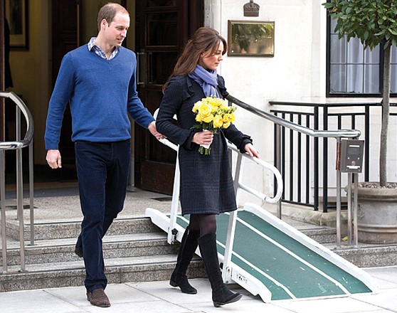 Britain's Prince William walks with his wife Kate, Duchess of Cambridge, as she leaves the King Edward VII hospital in central London.