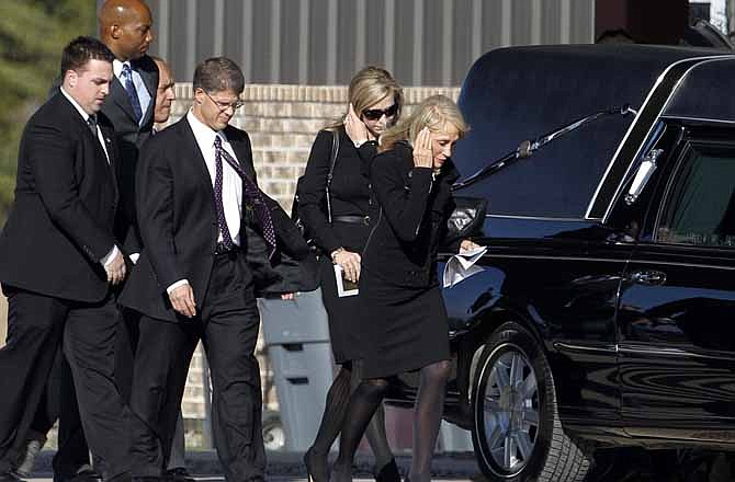 Kansas City Chiefs chairman Clark Hunt, third from right, leaves a funeral service for Kasandra Perkins at Ridgeview Family Fellowship Church Thursday, Dec. 6, 2012, in Blue Ridge, Texas. Perkins was shot and killed last Saturday by her boyfriend Jovan Belcher, a Chiefs football player. 