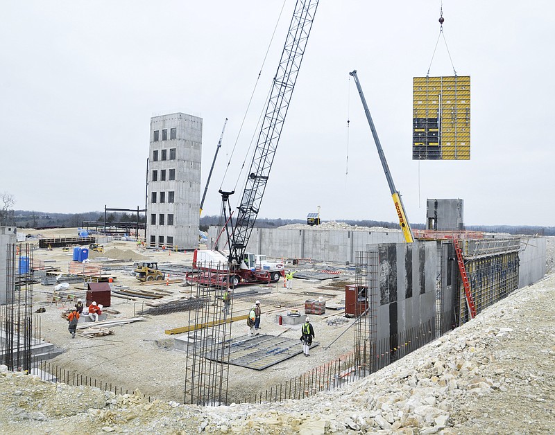 A concrete form section is hoisted over the wall as crews work to construct wall forms for a concrete pour at the new St. Mary's Health Center on Mission Drive. 