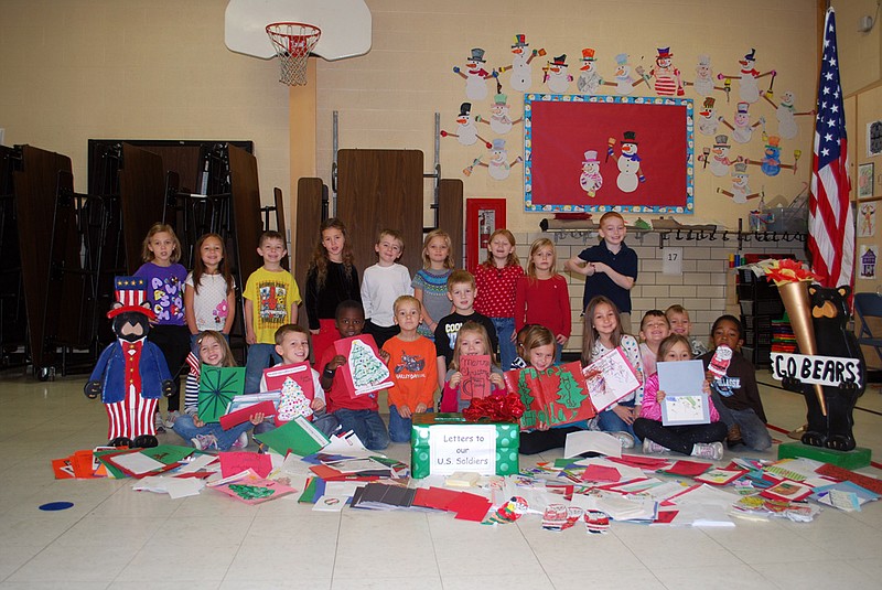 Shauna Smith's kindergarten students from McIntire Elementary pose with some of the more than 2,000 letters students, families and community members wrote for soldiers serving overseas. The school organized the drive in just one week in order to help Savannah's Soldiers, an organization that collects cards and letters for those serving in the military during the holidays.
